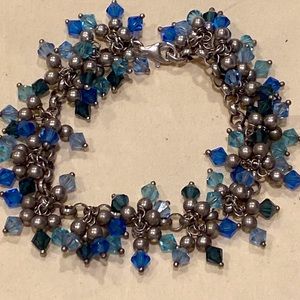 925 silver charm bracelet & lots of light & dark blue crystals signed “By Simon”